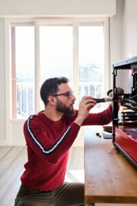 Young man screwing video card to PC